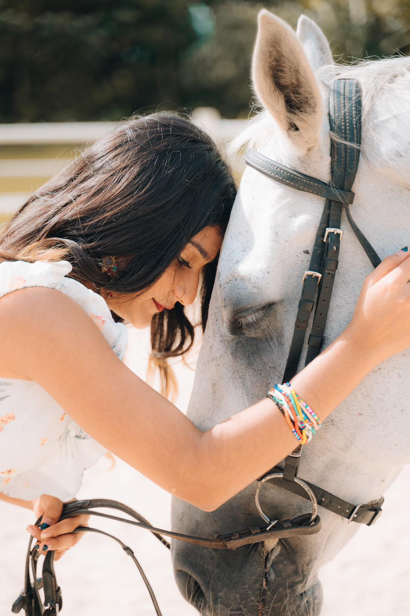 A guest posing with a horse during a photoshoot